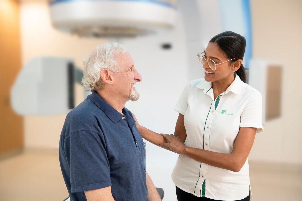 Doctor consulting elderly man in hospital