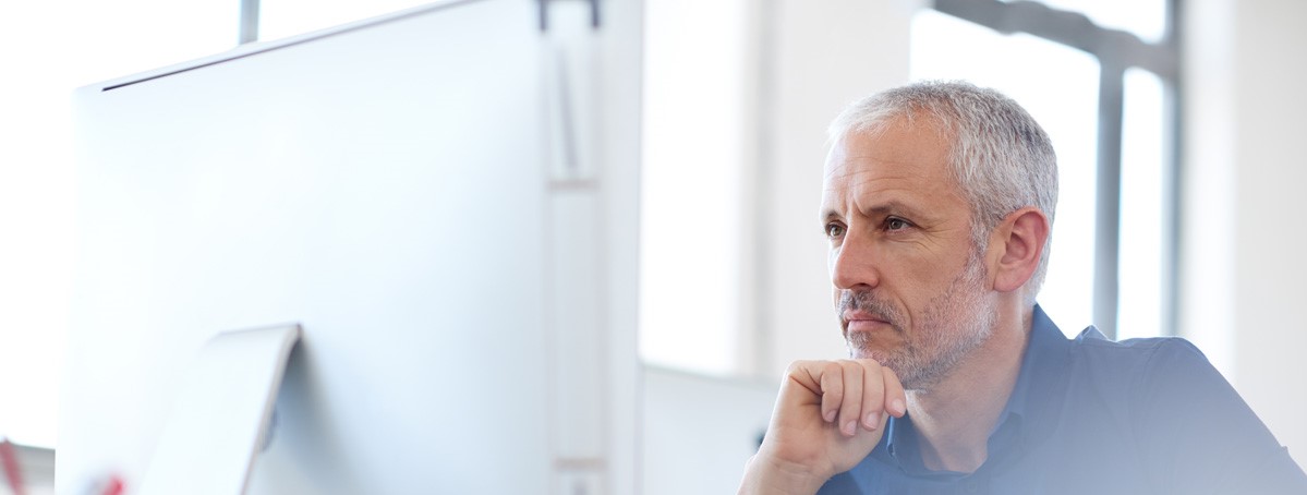 Low angle view of a mature professional man looking intently at his pchttp://195.154.178.81/DATA/shoots/ic_784739.jpg